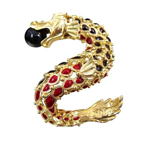 chanel dragon brooch.